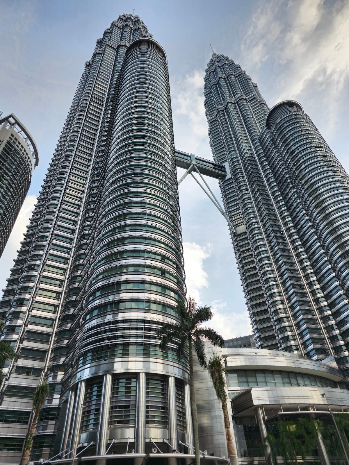 Daytime low-angle view of the iconic Petronas Twin Towers.