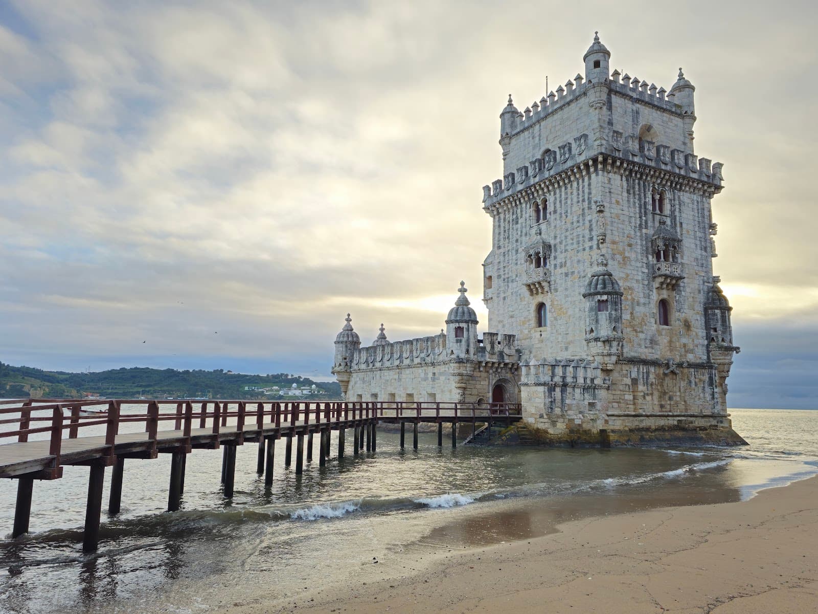 Iconic Belém Tower at sunset by the Tagus River.