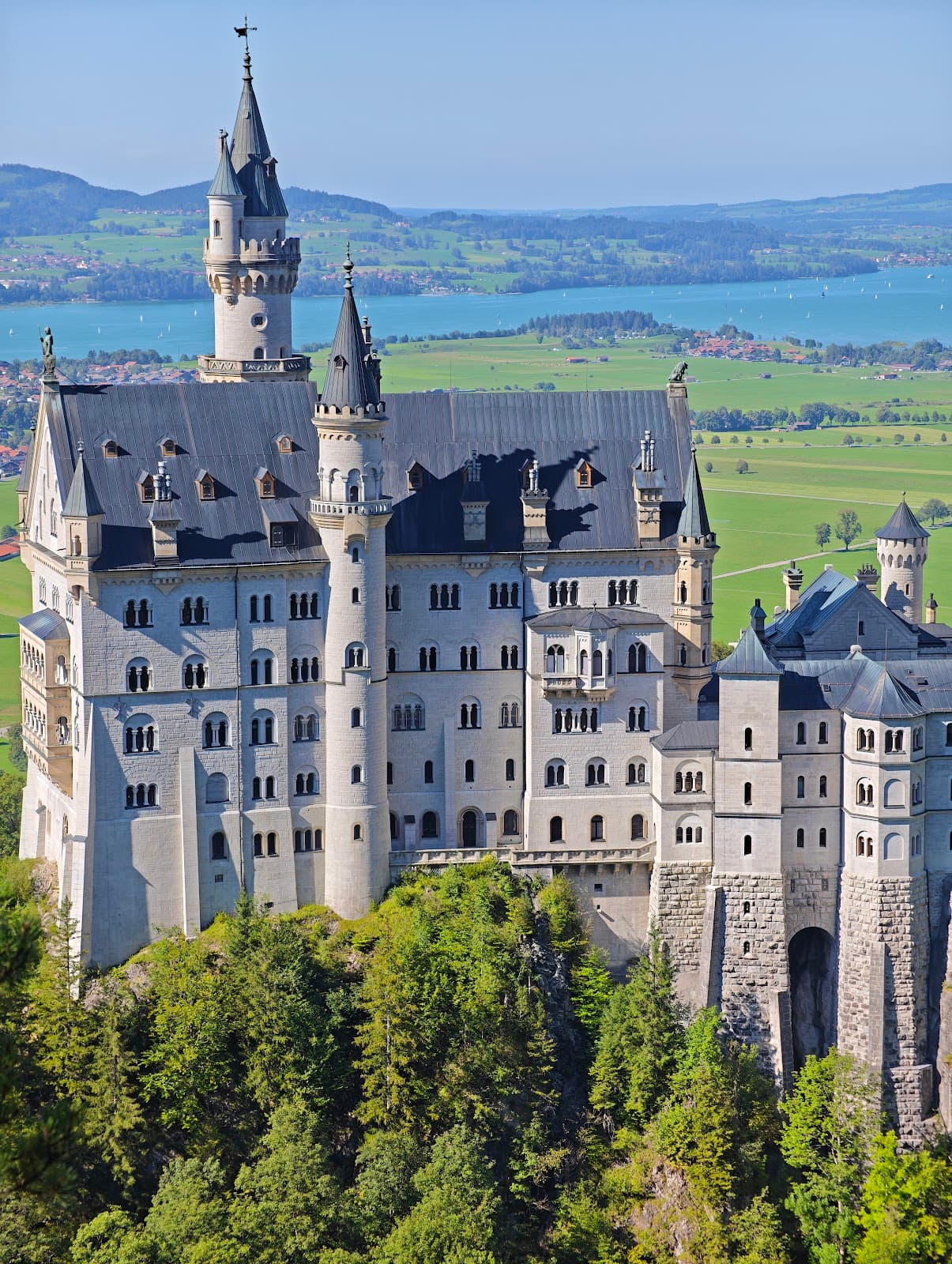 Iconic view of Neuschwanstein Castle overlooking the Bavarian landscape.