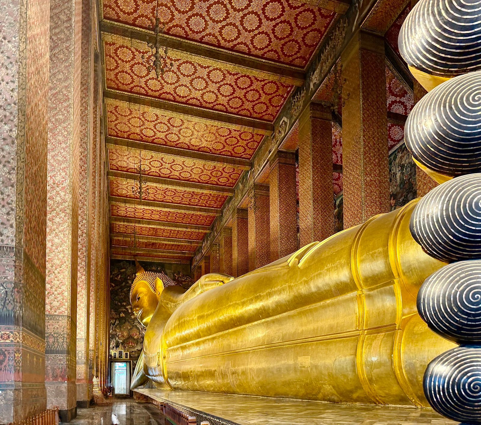 The iconic golden Reclining Buddha inside Wat Pho temple.