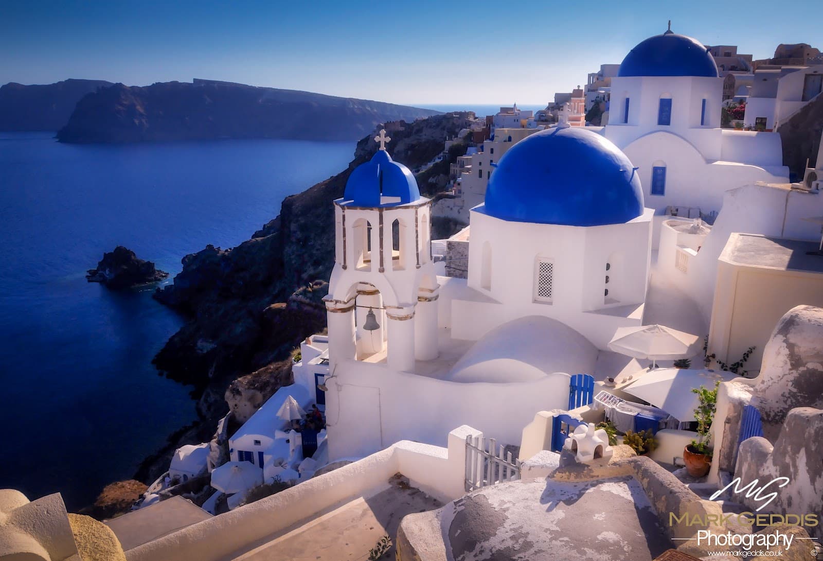 Iconic blue domes of Oia overlooking the Aegean Sea.