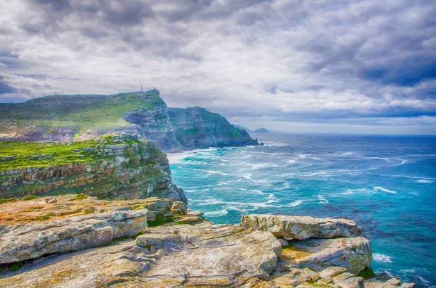 Iconic dramatic coastal cliffs and vibrant blue waters of the Cape.