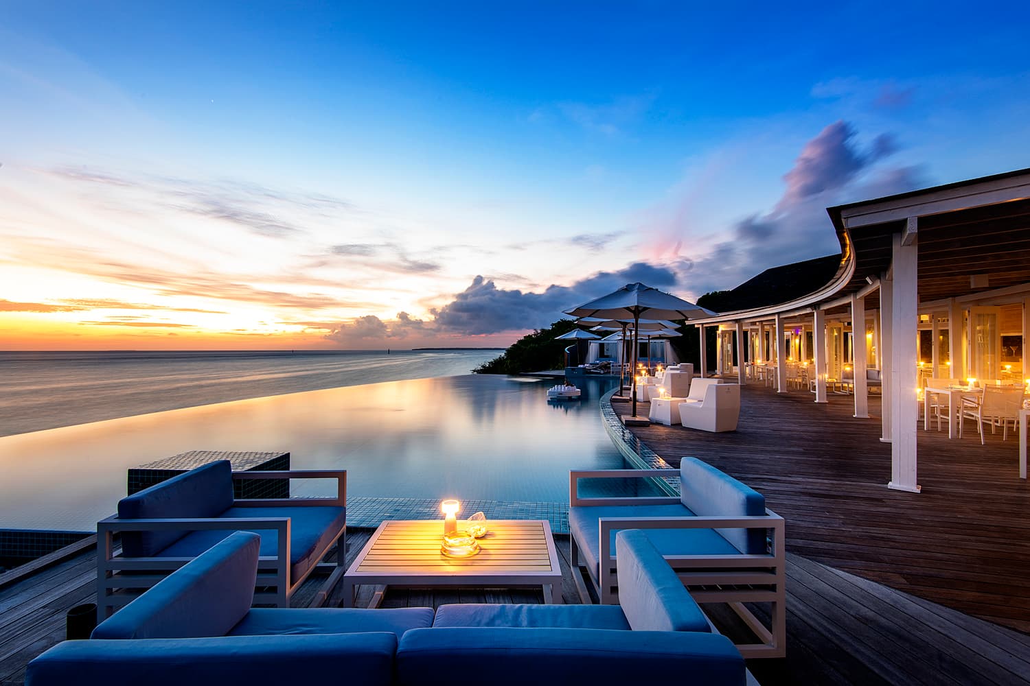 Stunning infinity pool at sunset with elegant lounge seating.