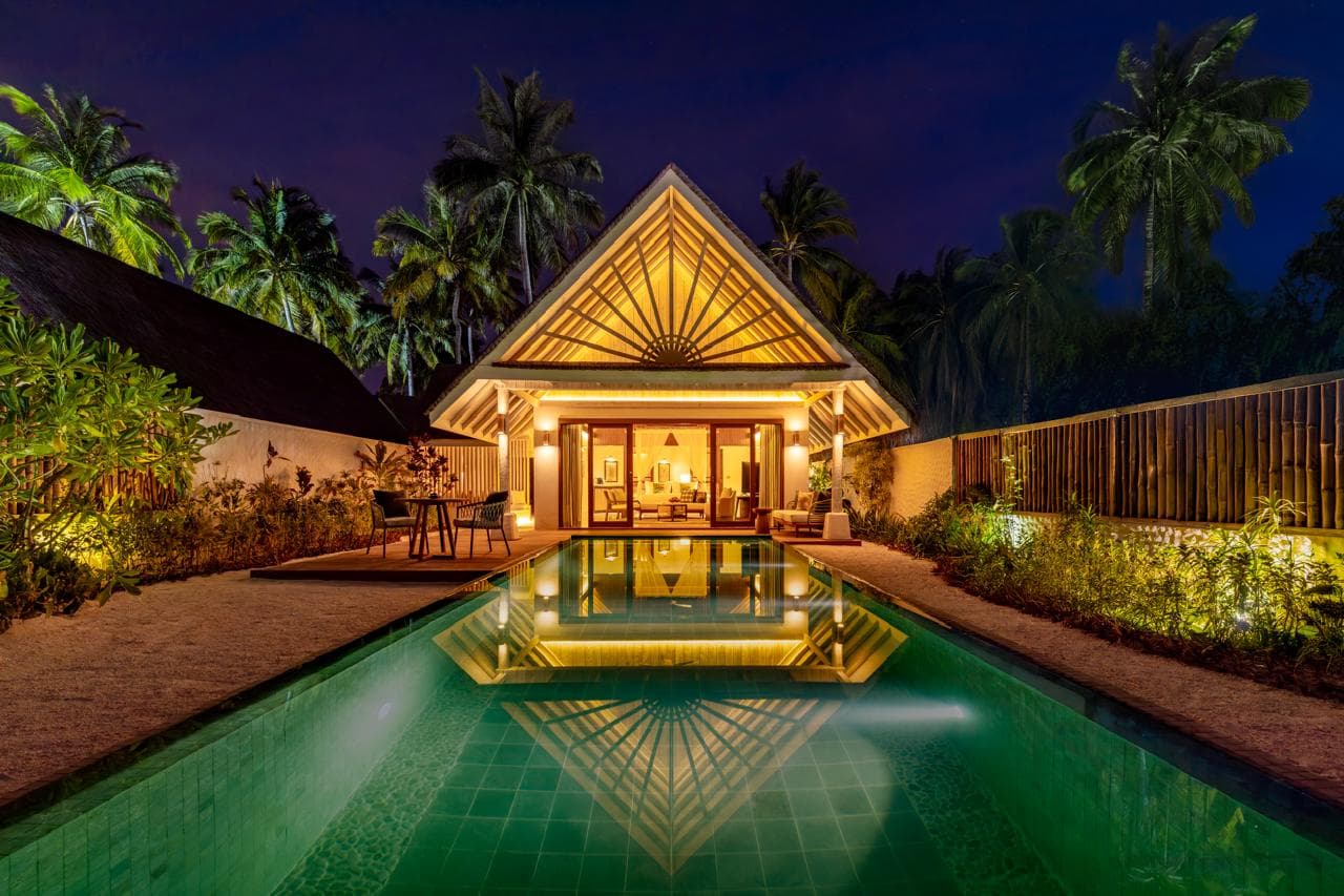 Stunning symmetrical night view of a private pool villa.