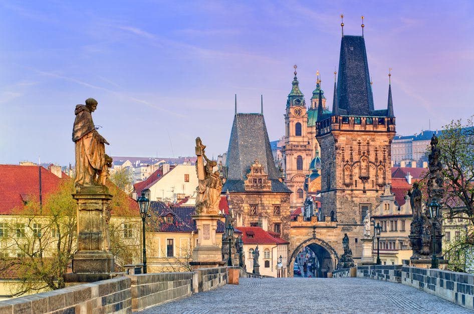 Iconic sunrise over Charles Bridge, perfect for a hero banner.