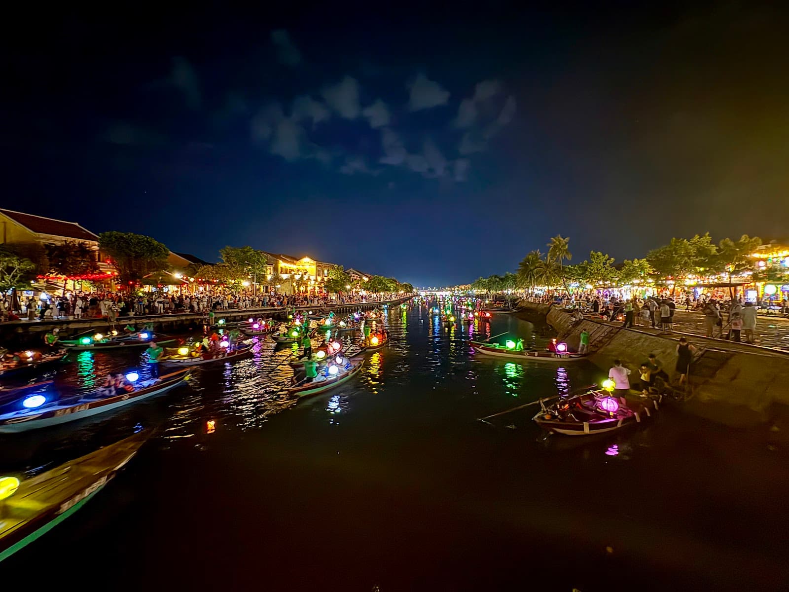 Beautiful night panorama of lantern boats on the river.
