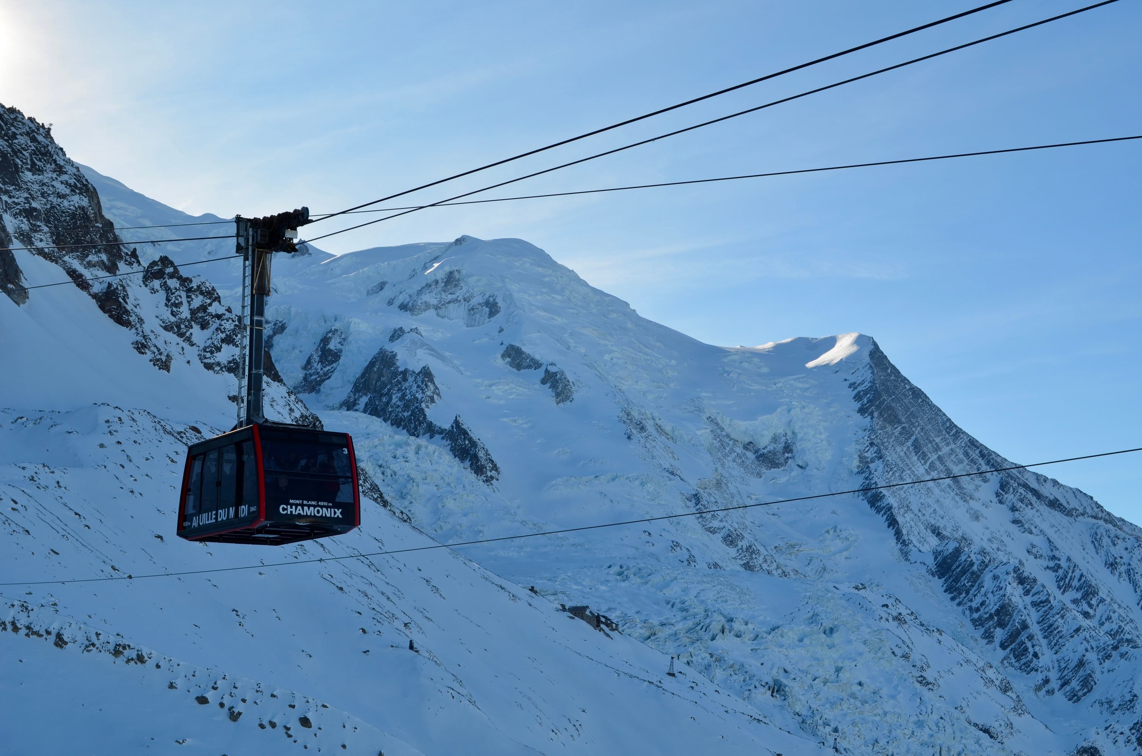 The iconic red cable car ascending towards Mont Blanc.