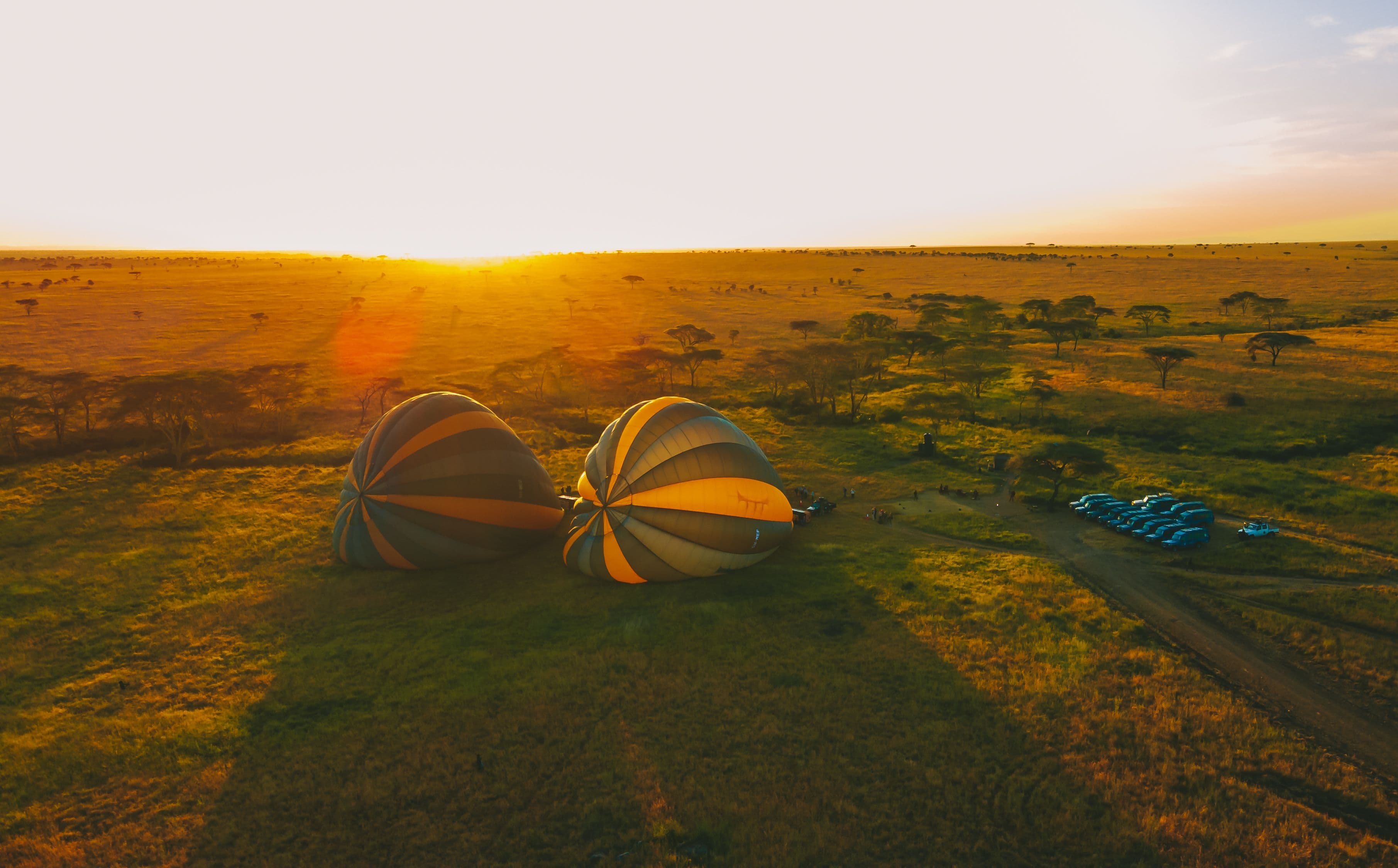 Iconic sunrise flight with balloons and the morning moon.