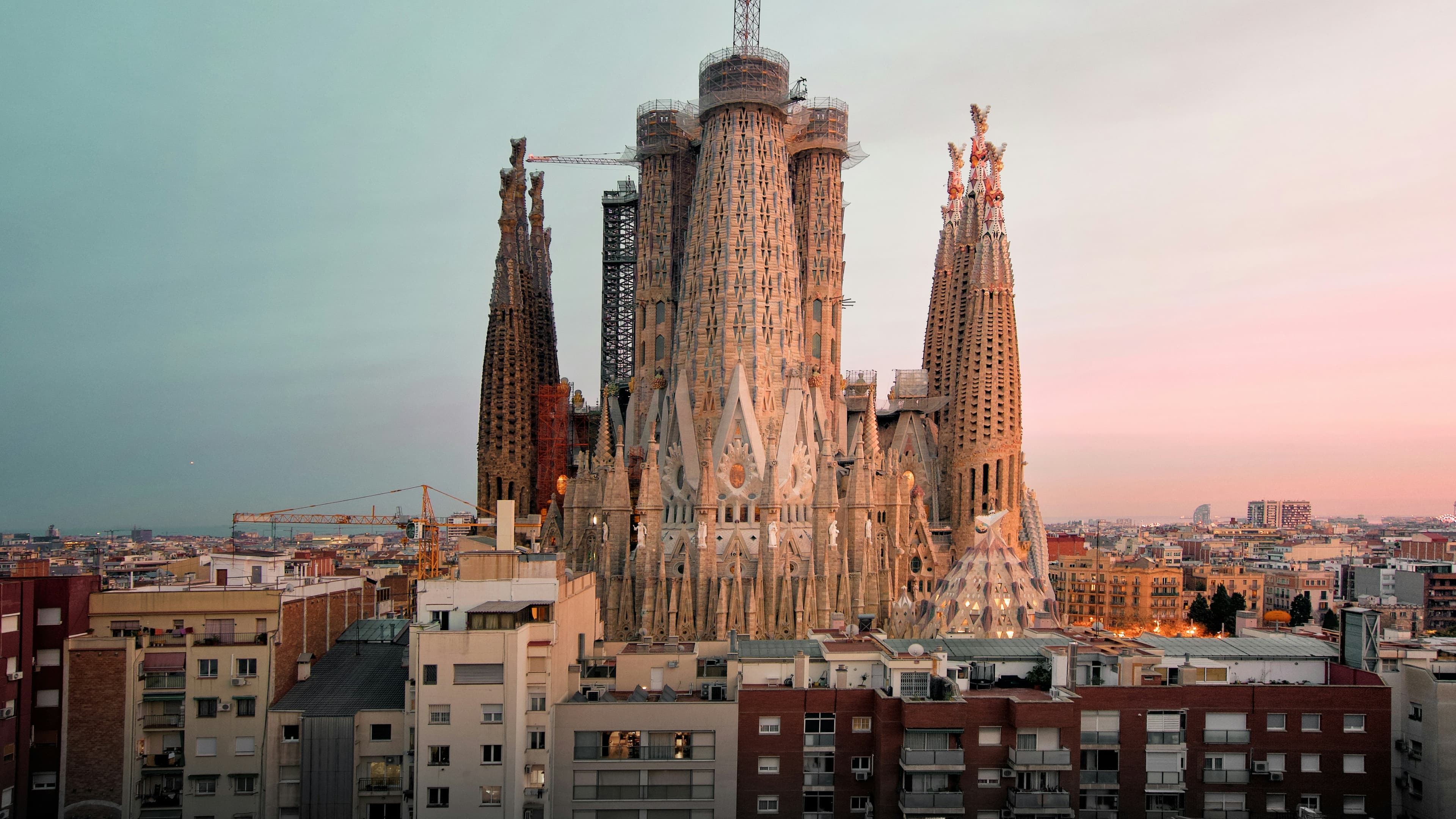 Iconic Barcelona skyline with the Sagrada Familia at sunset.