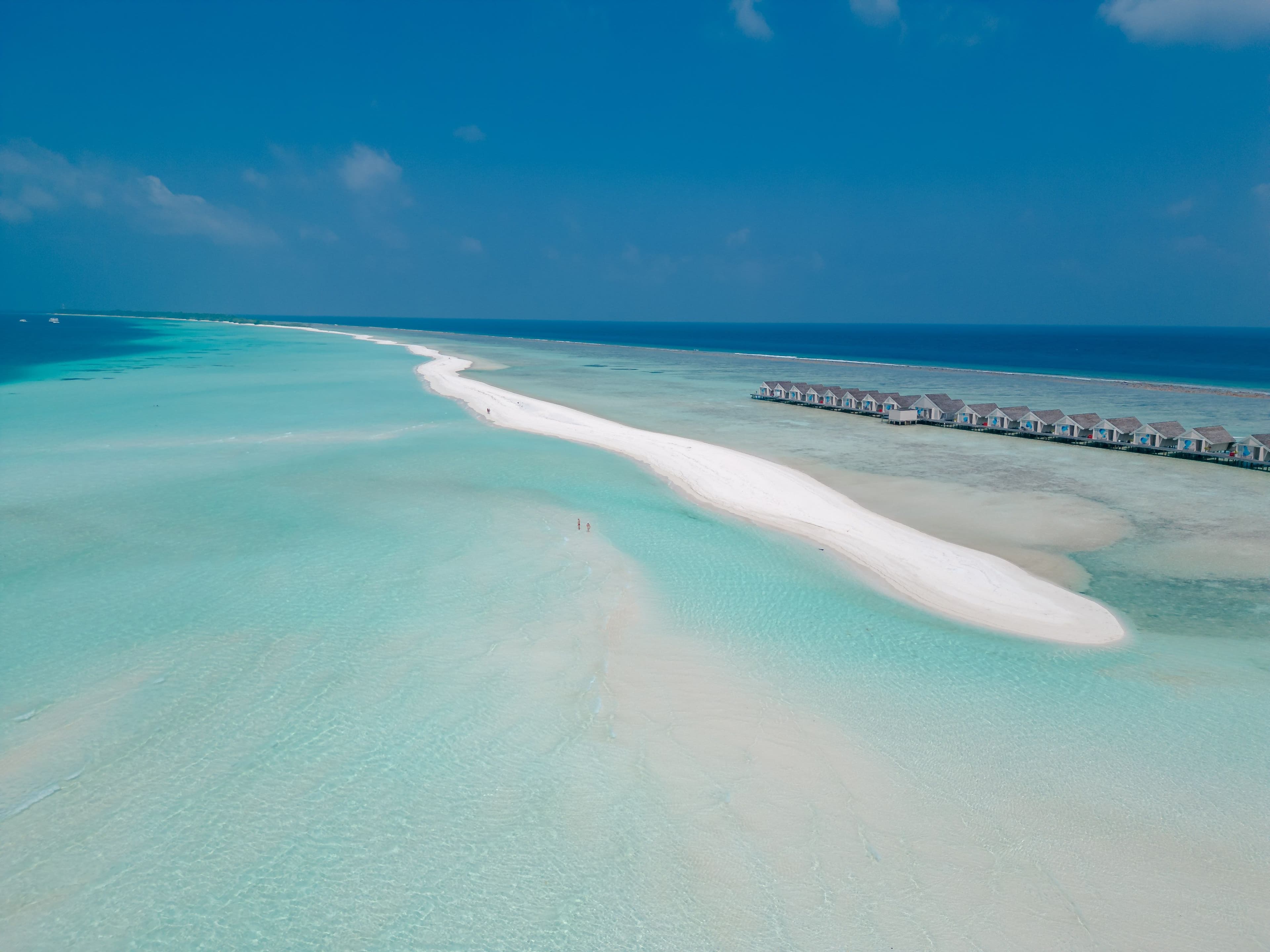Aerial view of Kuramathi sandbank in turquoise Maldivian waters.